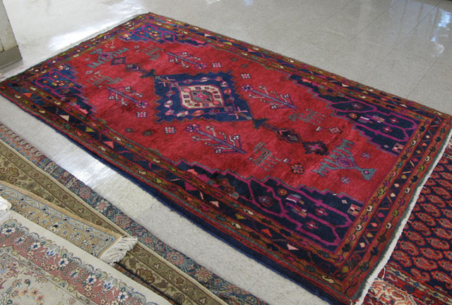 Appraisal: PERSIAN TRIBAL AREA RUG central geometric medallion flower and animal