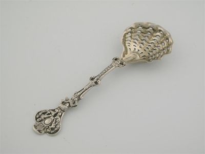 Appraisal: A Victorian cast sugar sifter ladle with a figure-decorated stem