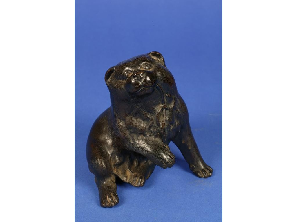 Appraisal: A JAPANESE BRONZE OF A PLAYFUL PUPPY with a raised