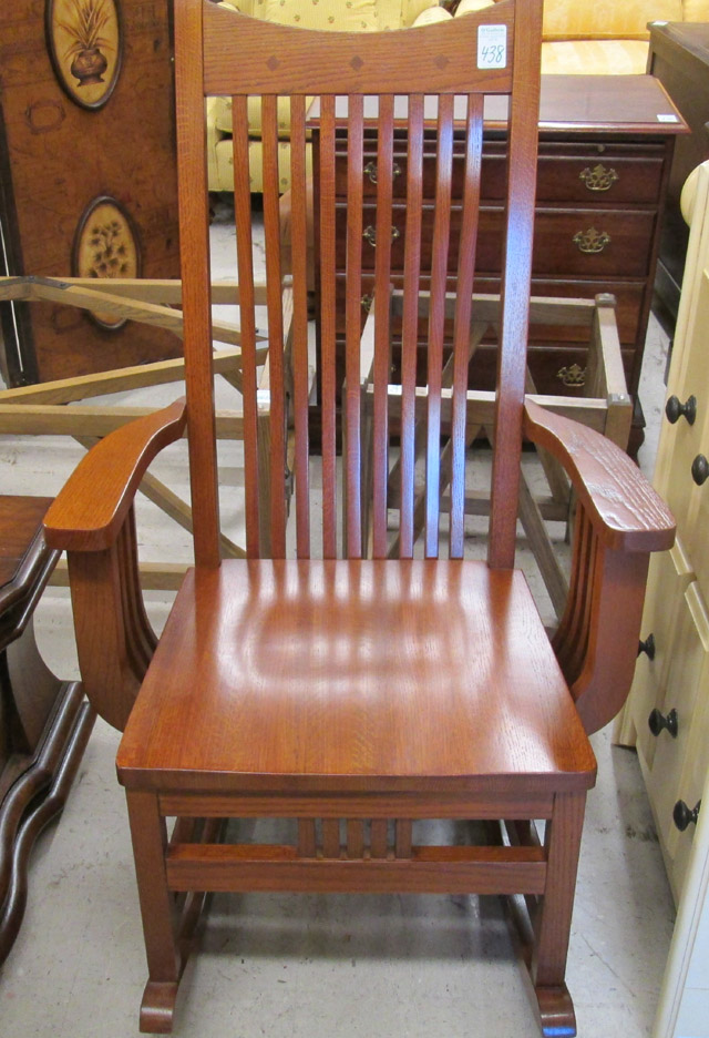 Appraisal: MISSION OAK ROCKER Arts Crafts design recent production having nine