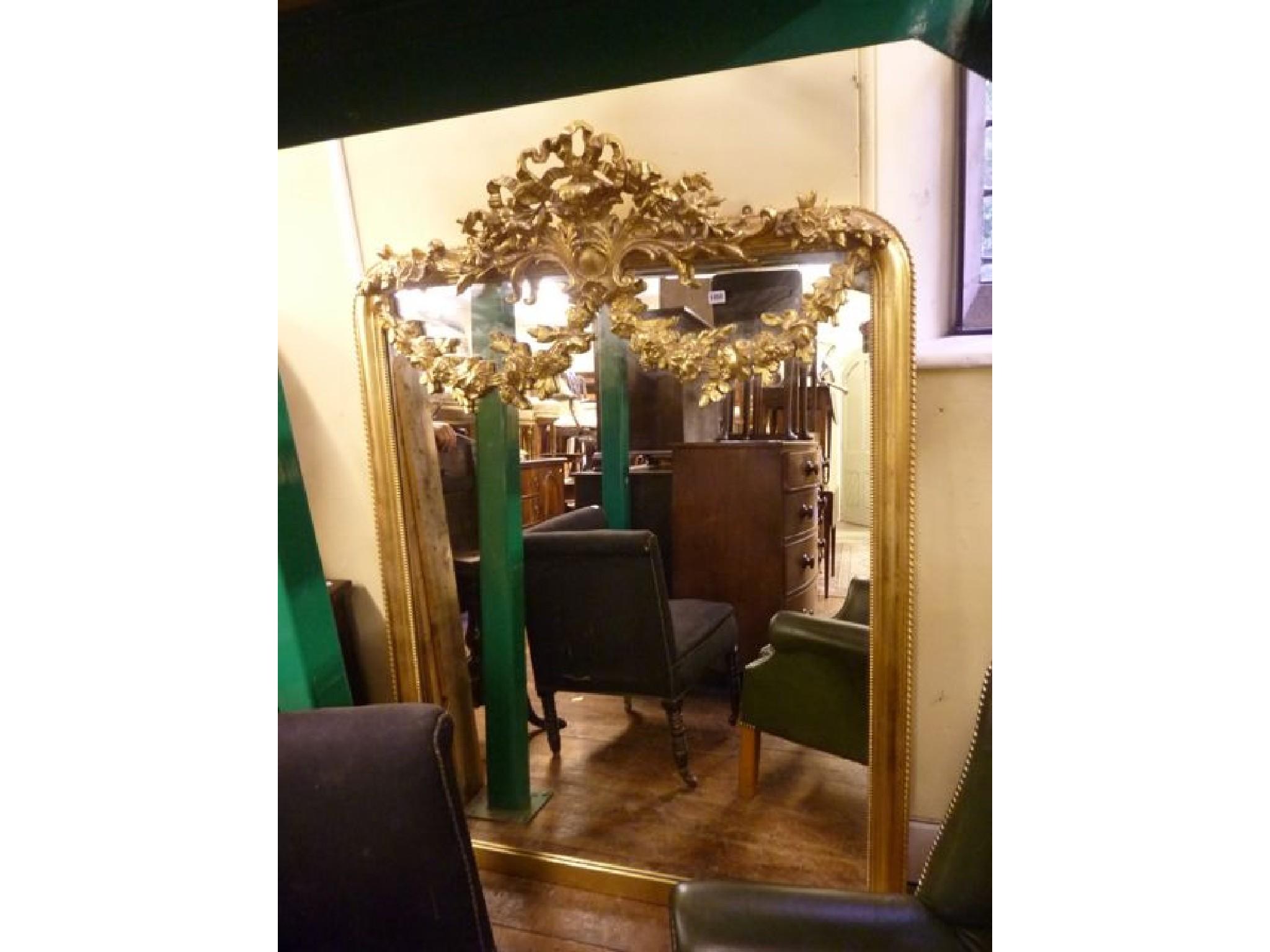 Appraisal: A gilt framed over mantle mirror of arched form with