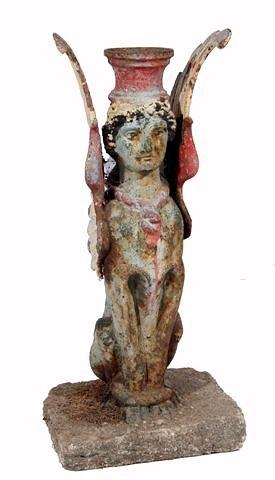 Appraisal: AN EGYPTIAN REVIVAL PAINTED CAST IRON WINGED SPHINX FIGURE on