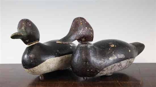 Appraisal: Two early th century painted pine decoy ducks with articulated