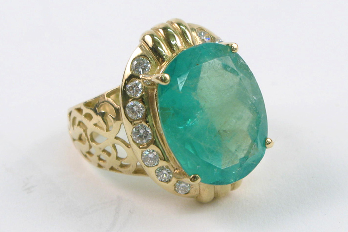 Appraisal: EMERALD DIAMOND AND FOURTEEN KARAT GOLD RING centering a large