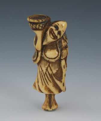 Appraisal: A Carved Staghorn Netsuke of a Man with Basket Edo