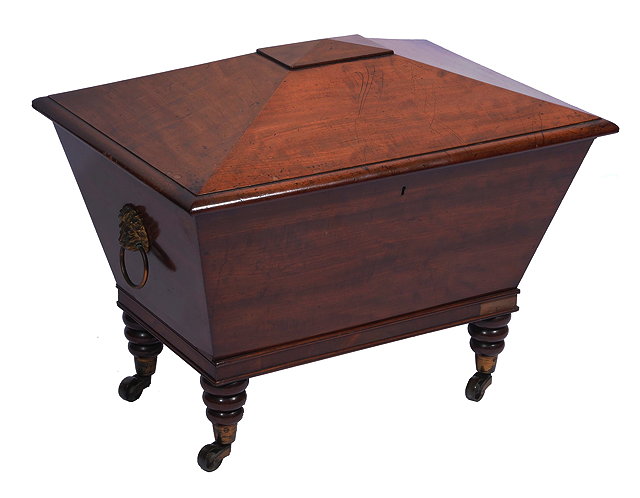 Appraisal: A REGENCY MAHOGANY CELERETTE of sarcophagus form with gilt lions