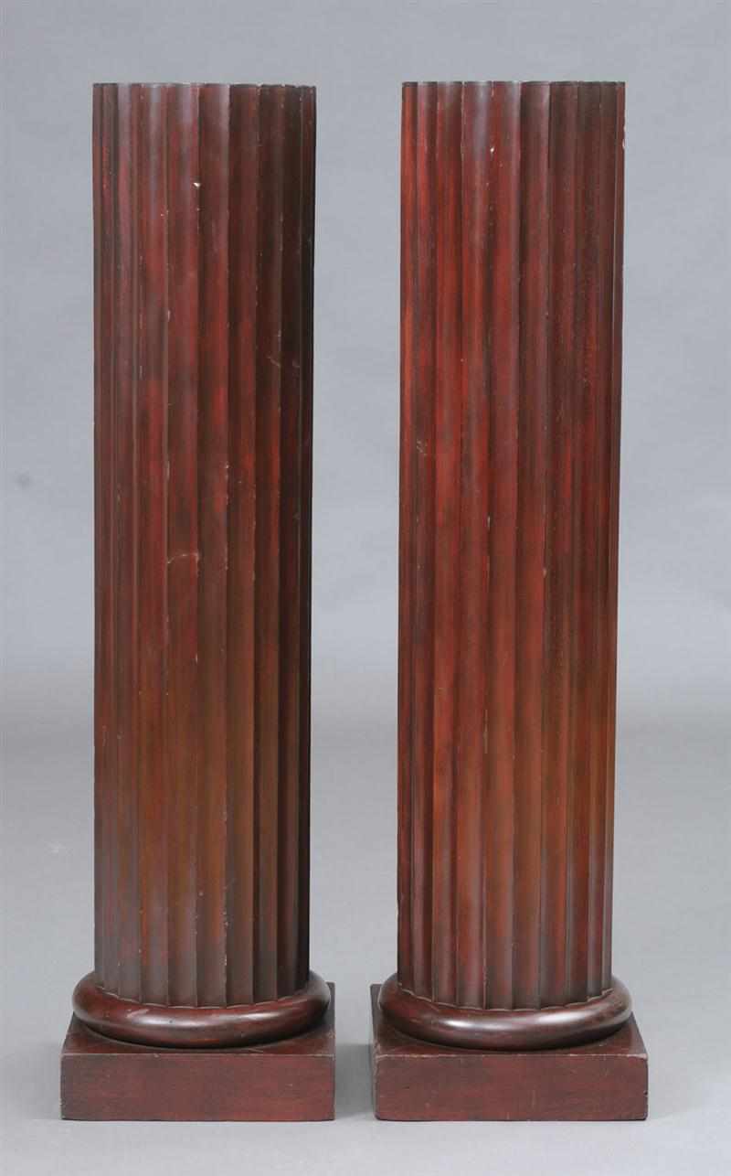 Appraisal: PAIR OF FLUTED MAHOGANY COLUMNS Each circular stem raised on