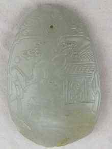 Appraisal: A Chinese jade ovate pendant carved in bas relief with