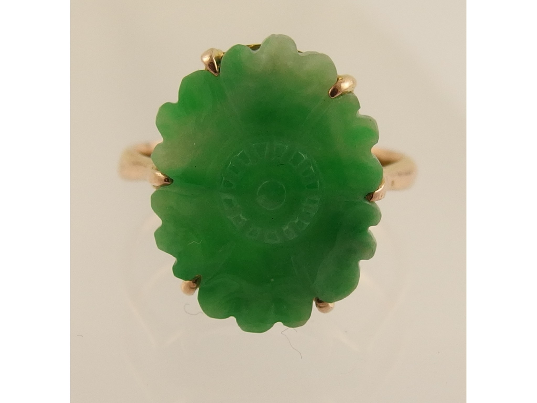 Appraisal: A ct ring set with a carved Chinese green hardstonecarved