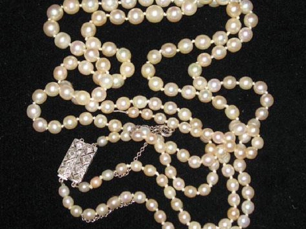 Appraisal: A DOUBLE STRAND GRADUATED PEARL NECKLACE with an adjustable diamond