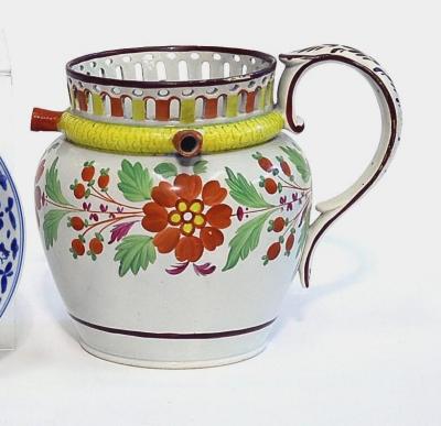 Appraisal: A PEARLWARE PUZZLE JUG of baluster form with pierced rim