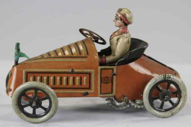 Appraisal: GUNDKA OPEN TOURER Germany lithographed tin seated driver brown auto