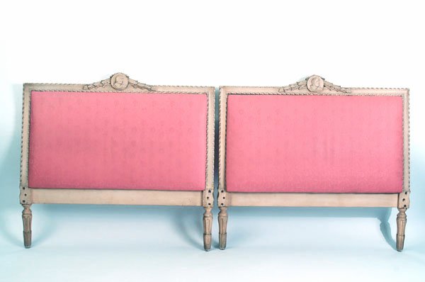 Appraisal: Pair of upholstered headboards with cream painted carved frames and