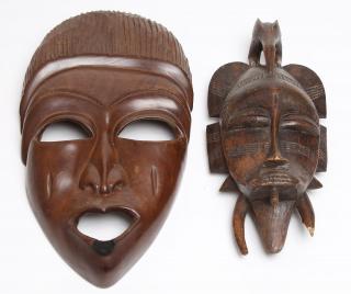 Appraisal: African Masks Possibly Senufo one man depicted with a winged