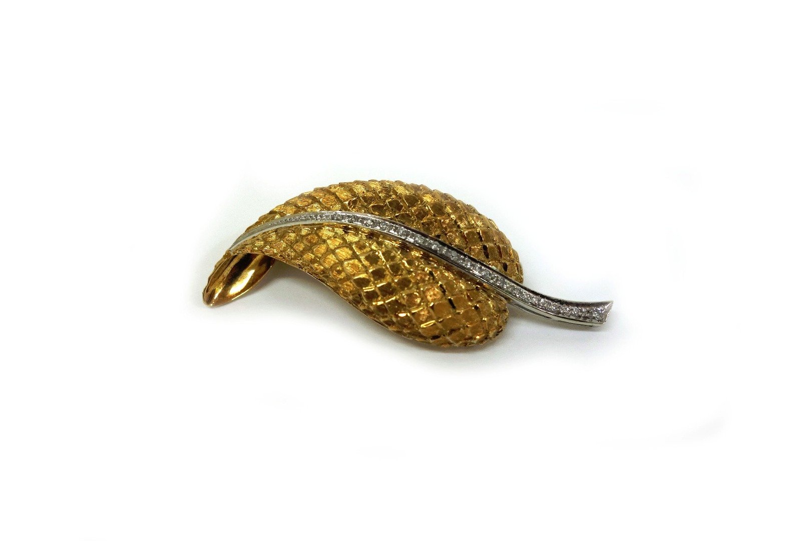 Appraisal: A gold and diamond leaf brooch with textured finish and