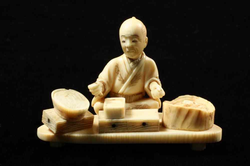 Appraisal: IVORY NETSUKE - Street Food Vendor seated on three-footed platform