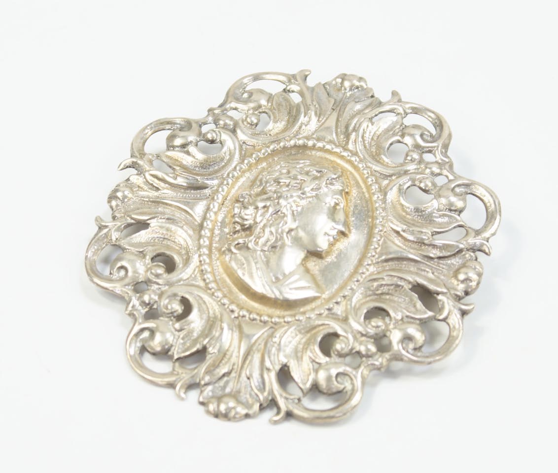 Appraisal: A rococo design brooch cast in white metal unmarked