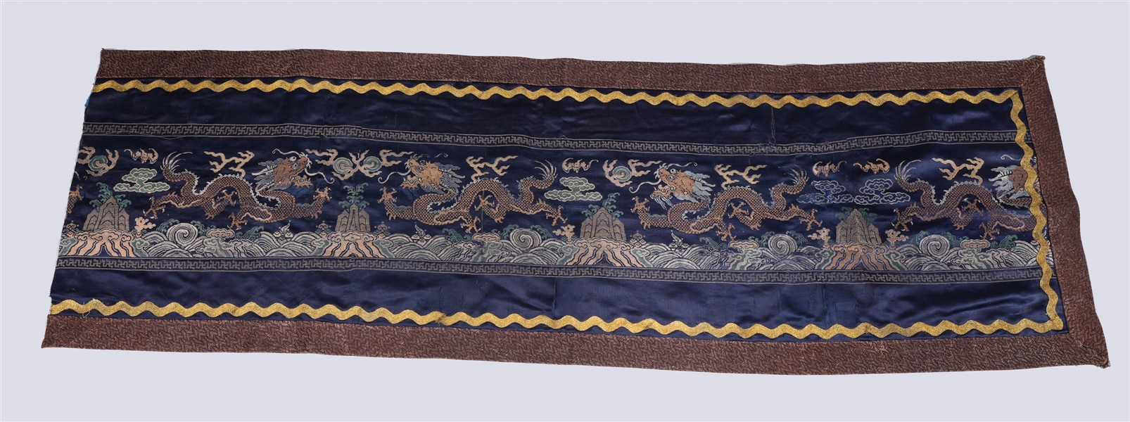 Appraisal: Section of a Chinese silk embroidered panel with dragons chasing