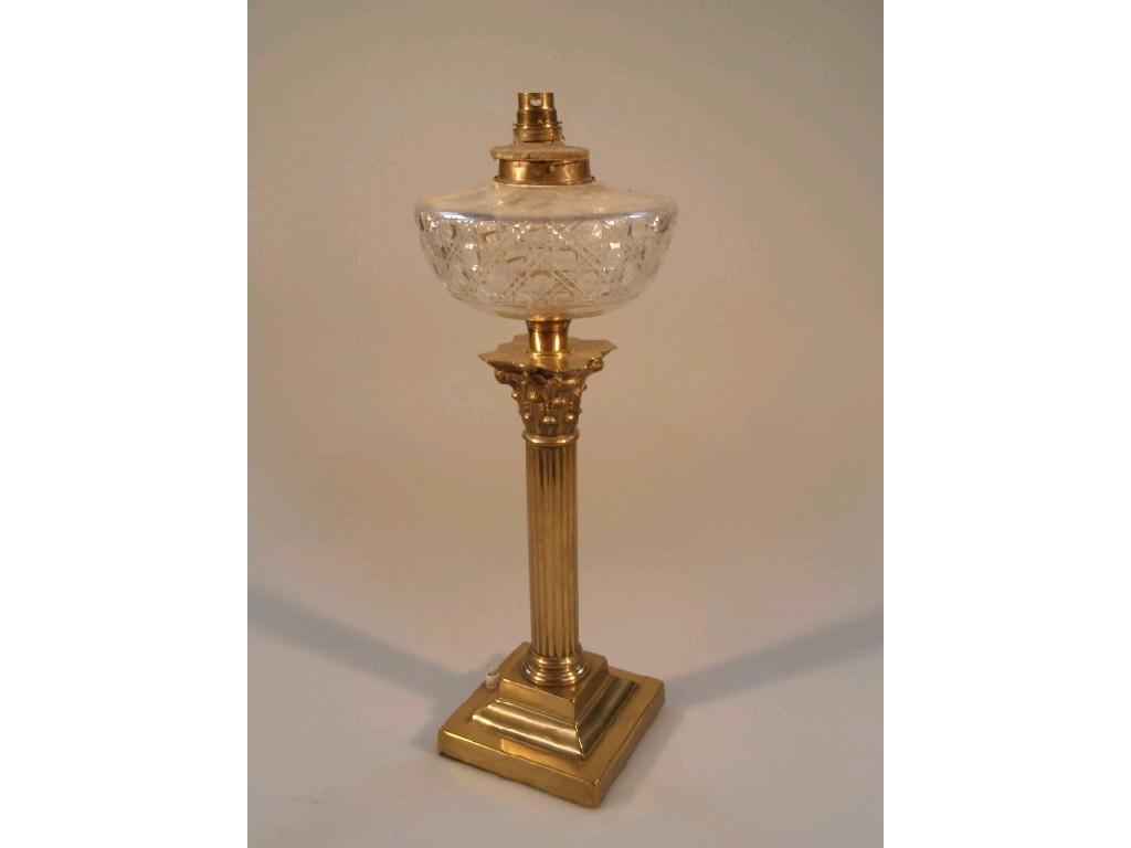 Appraisal: An oil lamp with cut glass reservoir brass Corinthian stand