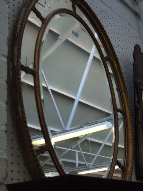 Appraisal: A th century gilt framed oval wall mirror of sectional