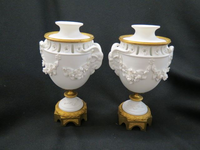 Appraisal: Pair of French Bronze and Bisque Urns rams head and