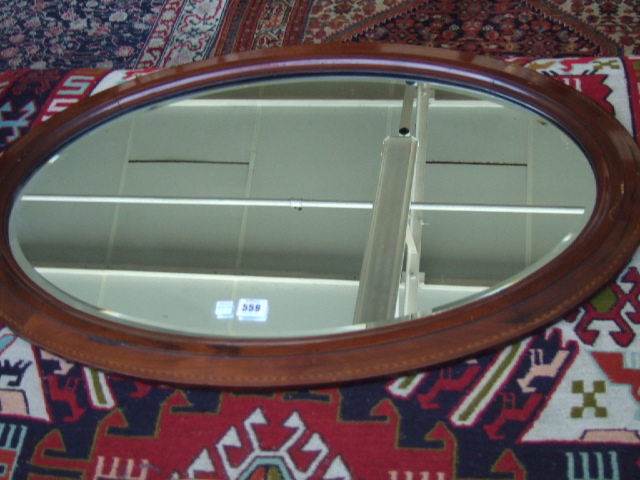 Appraisal: A mahogany and chequered strung oval mirror cm wide