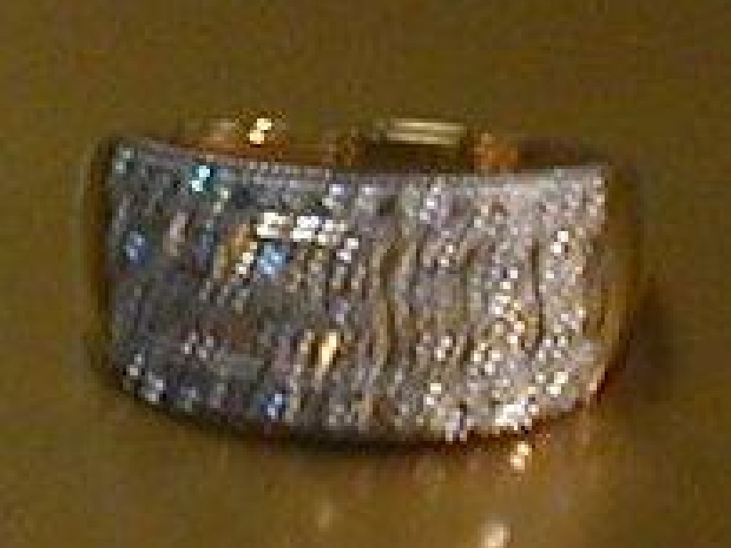 Appraisal: A dress ring a wide pierced band of bars set