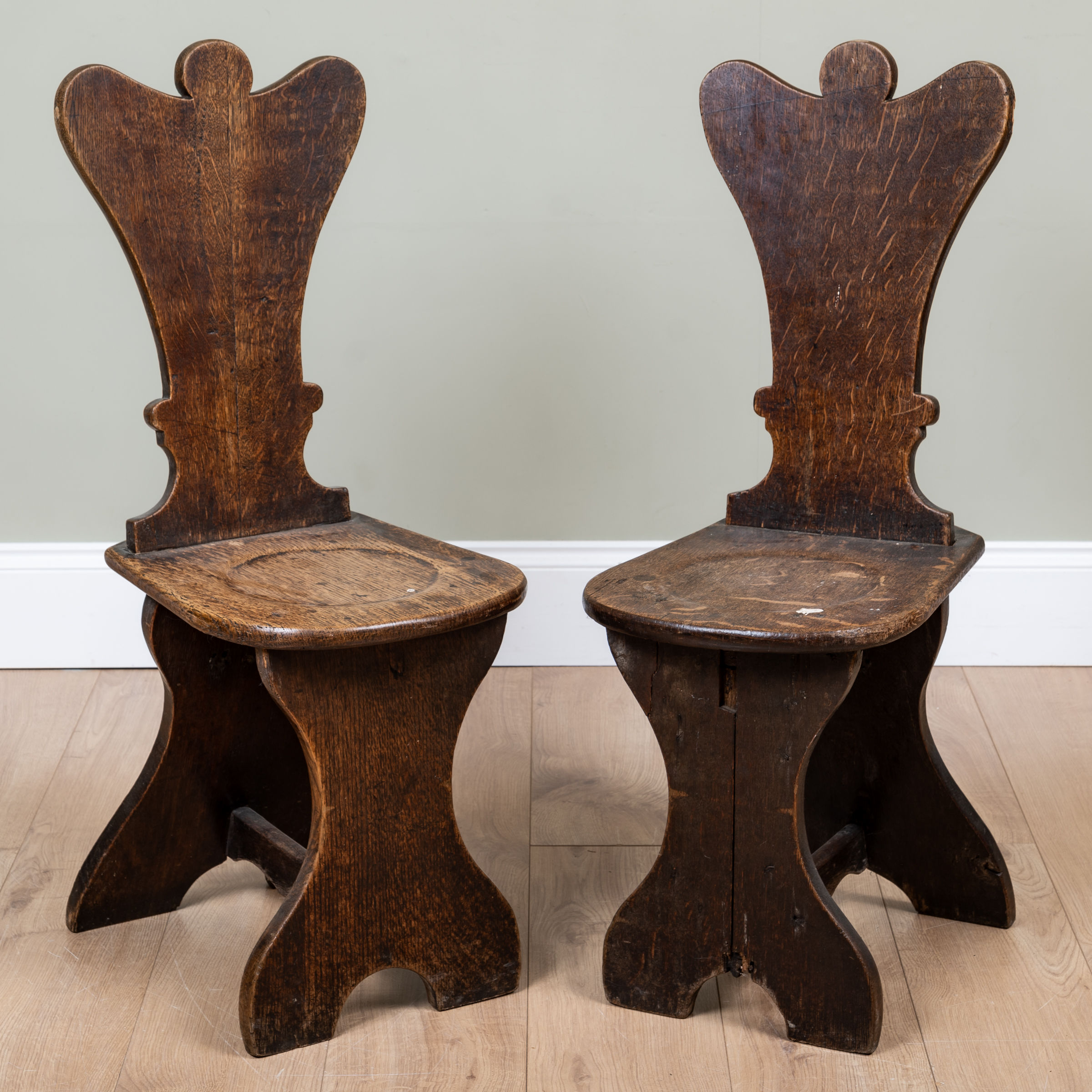 Appraisal: A pair of George III oak hall chairs of Sgabello