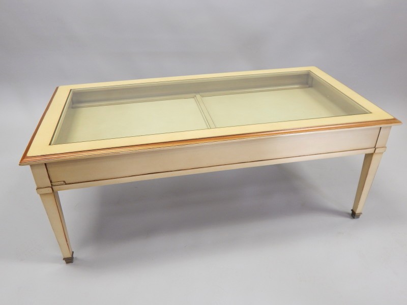 Appraisal: A modern cream painted display table with a glazed top