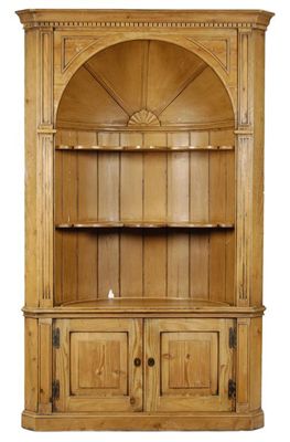 Appraisal: A pine standing corner cupboard the moulded cornice above a