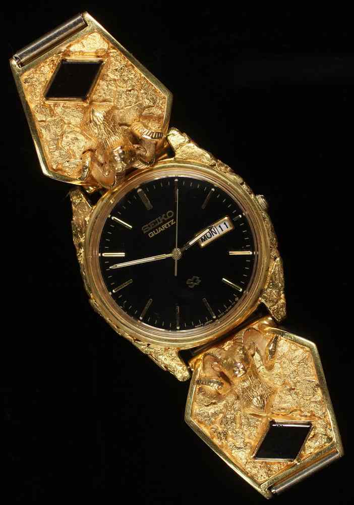 Appraisal: GENT'S WATCH - One custom gold nugget cased Seiko quartz