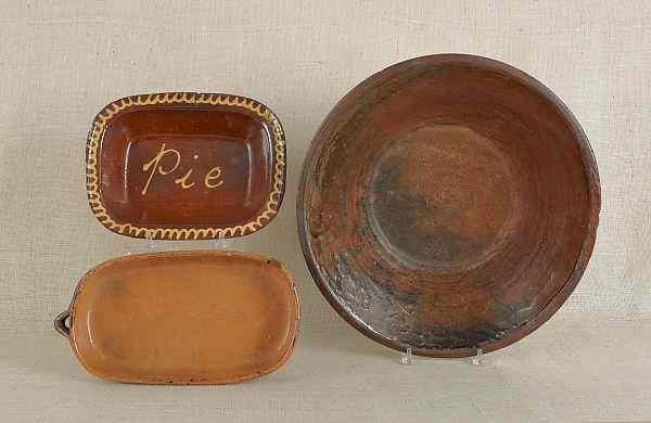 Appraisal: Large redware milk pan th c together with two loaf