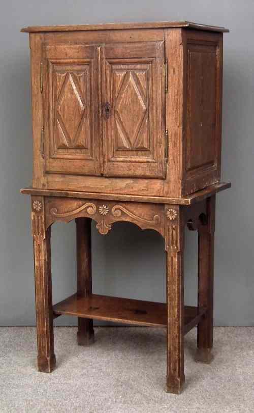 Appraisal: A French panelled oak cabinet fitted single drawer enclosed by