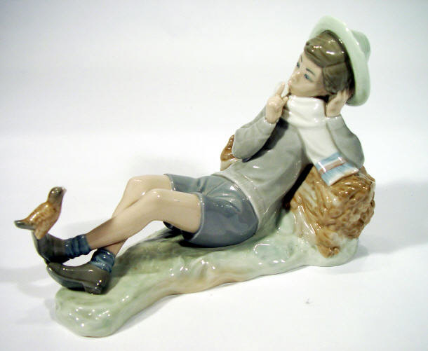 Appraisal: Lladro porcelain figure a boy beside a log with bird