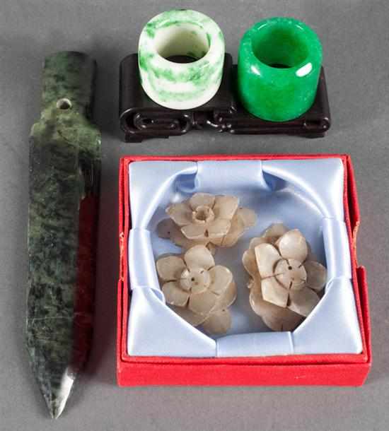 Appraisal: Two Chinese carved jade archer's rings carved jade floral adornments