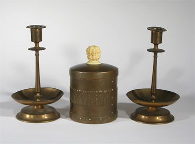 Appraisal: A pair of Arts and Crafts patinated copper candlesticks possibly