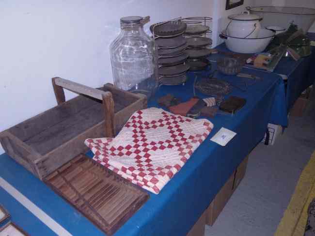 Appraisal: Misc table lot including enamelware pie racks childs quilt whirligig