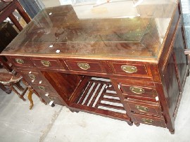 Appraisal: An oriental glass topped twin pedestal desk with ten drawers