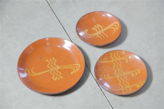 Appraisal: THREE GREG SHOONER REDWARE PLATE Each with yellow slip decoration