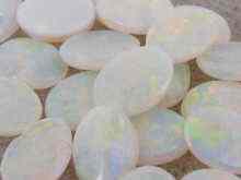 Appraisal: A quantity of white opals all oval approx x mm