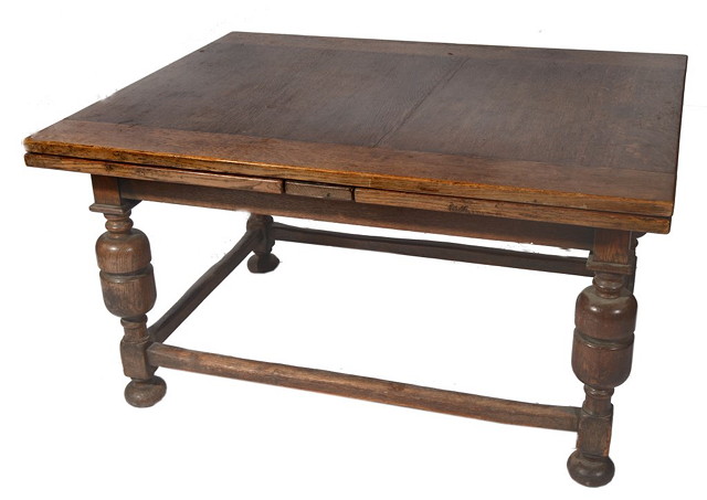 Appraisal: A LARGE OAK DRAW LEAF DINING TABLE on baluster supports