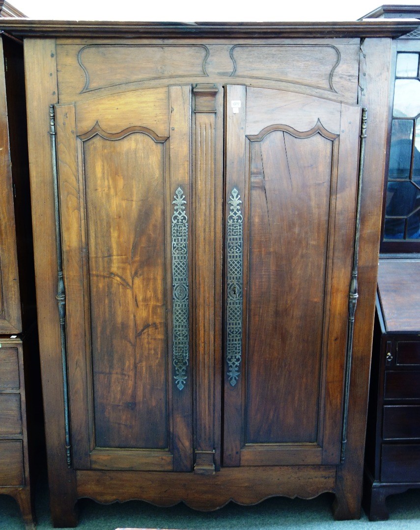 Appraisal: An th century French chestnut two door armoire on shaped