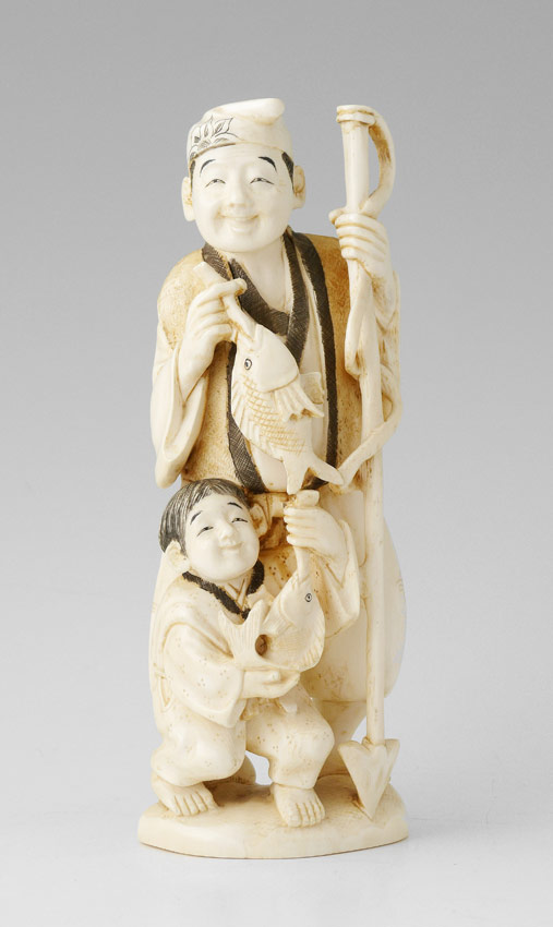 Appraisal: JAPANESE CARVED IVORY FIGURAL GROUP Carved grouping of a man