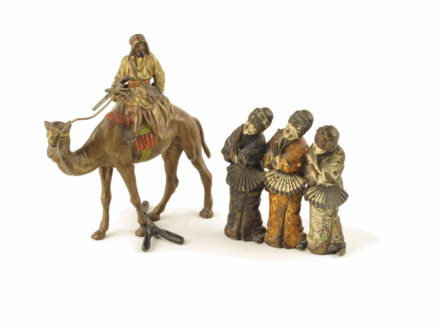 Appraisal: An Austrian cold painted bronze Arab holding a rifle seated