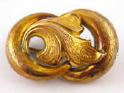 Appraisal: A Victorian carat gold scroll brooch with engraved decoration approx