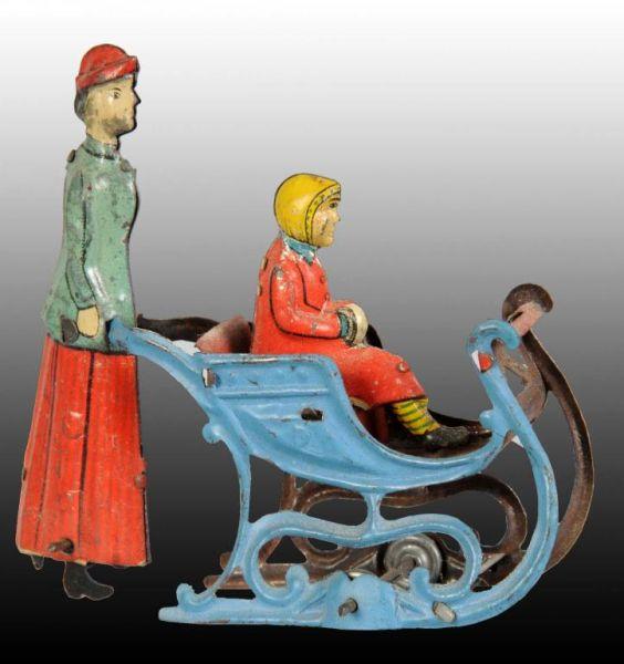 Appraisal: Tin Woman Pushing Girl in Sled Penny Toy Description German