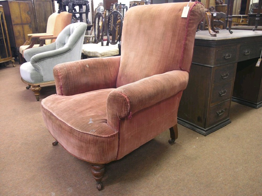 Appraisal: A Victorian armchair upholstered in a claret fabric on front