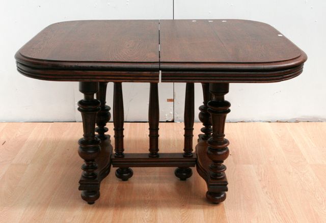 Appraisal: A late th century French oak dining table with two