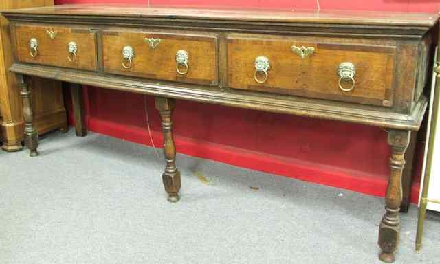 Appraisal: An oak dresser the three drawers crossbanded in fruitwood on