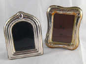 Appraisal: Two modern silver faced photo frames one with shaped arch